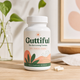 Guttiful gut health supplement bottle on a wooden counter with a plant in the background